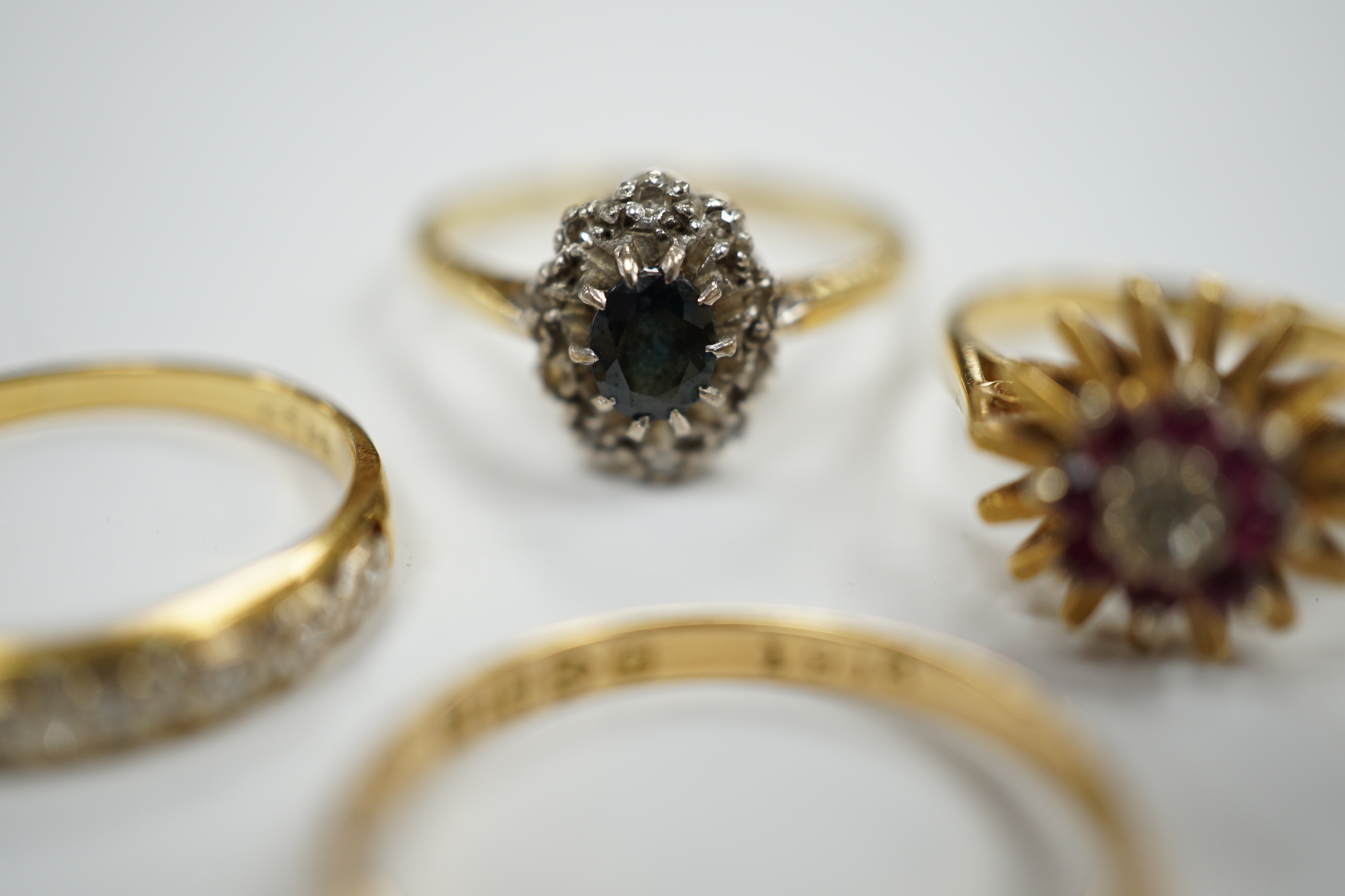 Four assorted Edwardian and later 18ct and gem set rings, including sapphire and diamond chip, size O, gross weight 12.1 grams.